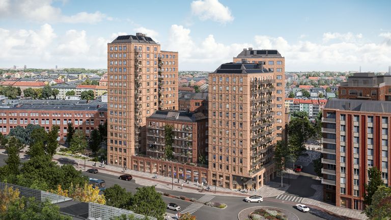 Kvarteret Tegeltornen med fyra höghus med tegelfasad med balkonger, omgivna av träd och livliga gator.