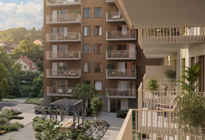 Moderna flerbostadshus med balkonger. En grön innergård med sittplatser och planteringar.