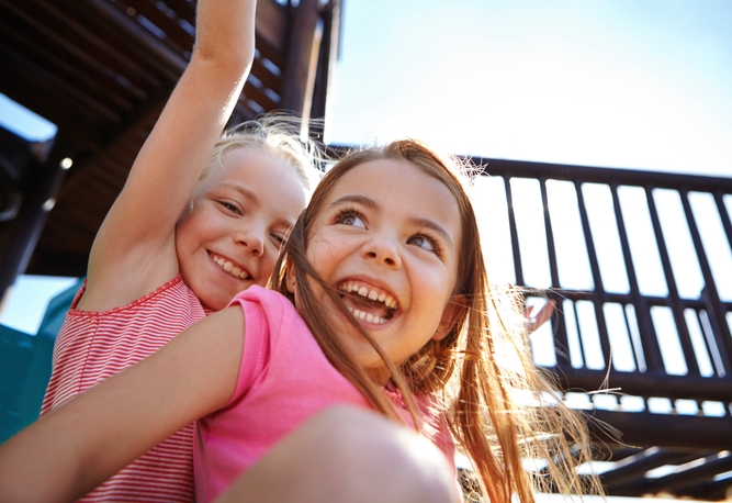 Två barn som leker på en lekplats.