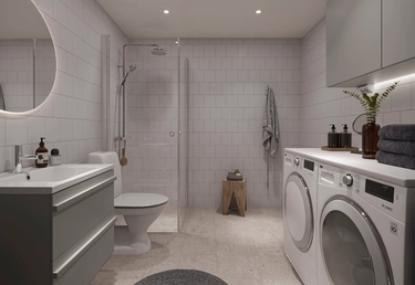 Badrum i House of Nelly med kommod, takdusch, tvättmaskin och torktumlare.