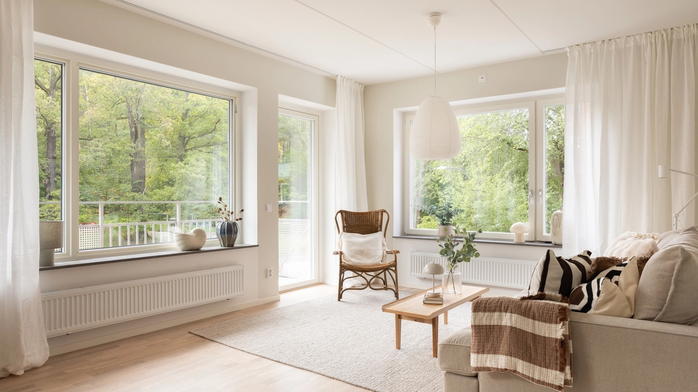 Vardagsrum i Grönskan med utsikt mot träd.